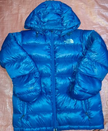 Le manteau en duvet The North Face avec code